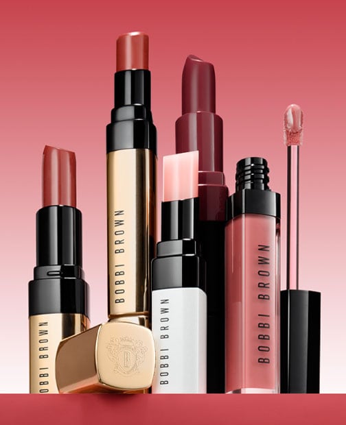 Visual close up group shot of lip gloss, lipstick, crushed lip and lip tint products 